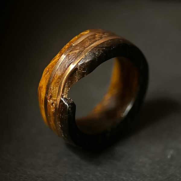 broken whiskey barrel ring with two copper ring inlays