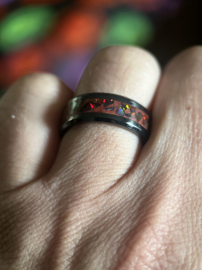 Alternative wedding rings made with ceramic core, opal, and red pigment.