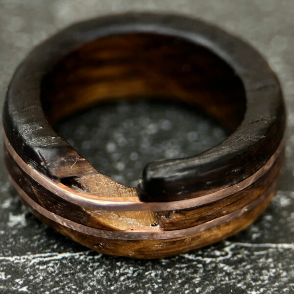 Broken whiskey barrel ring with two shiny brass rings