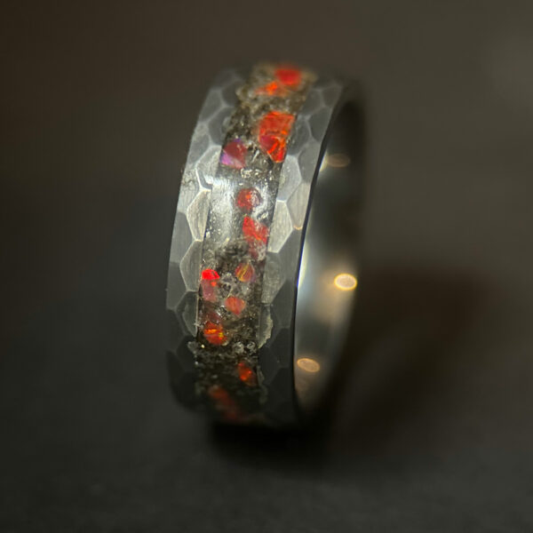 Meteorite ring with red opal inlay and a hammered tungsten comfort core.