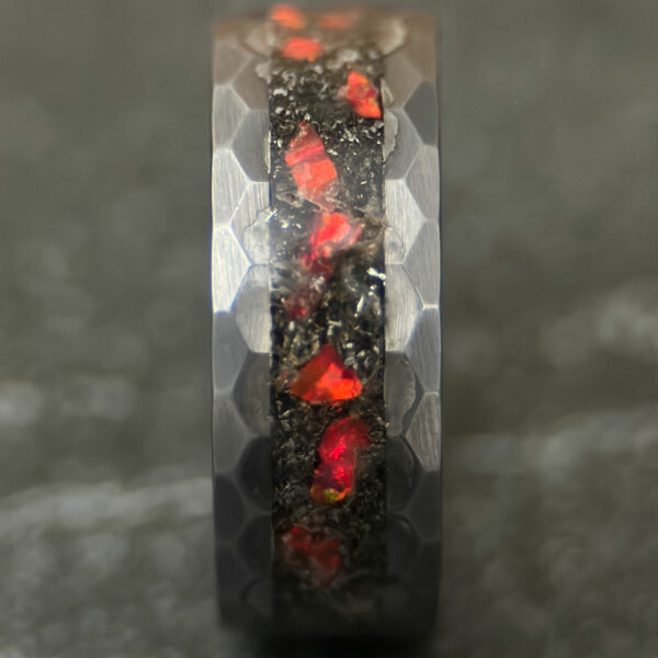 Meteorite ring with red opal inlay and a hammered tungsten comfort core.