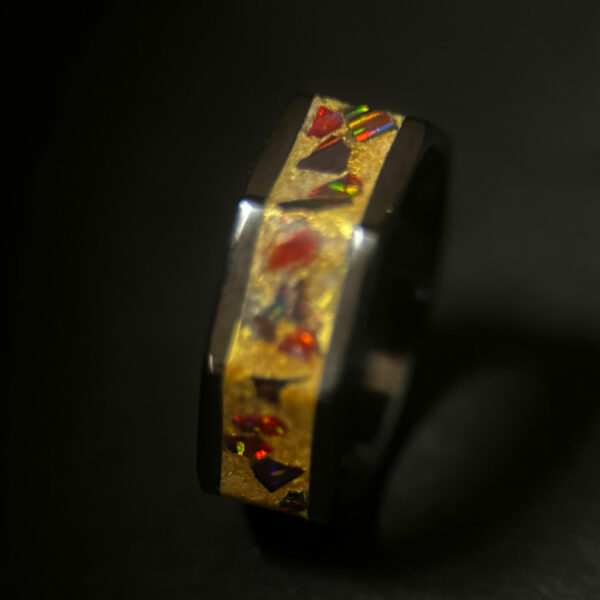 Octagon black ceramic ring with golden dust and red opal inlay.