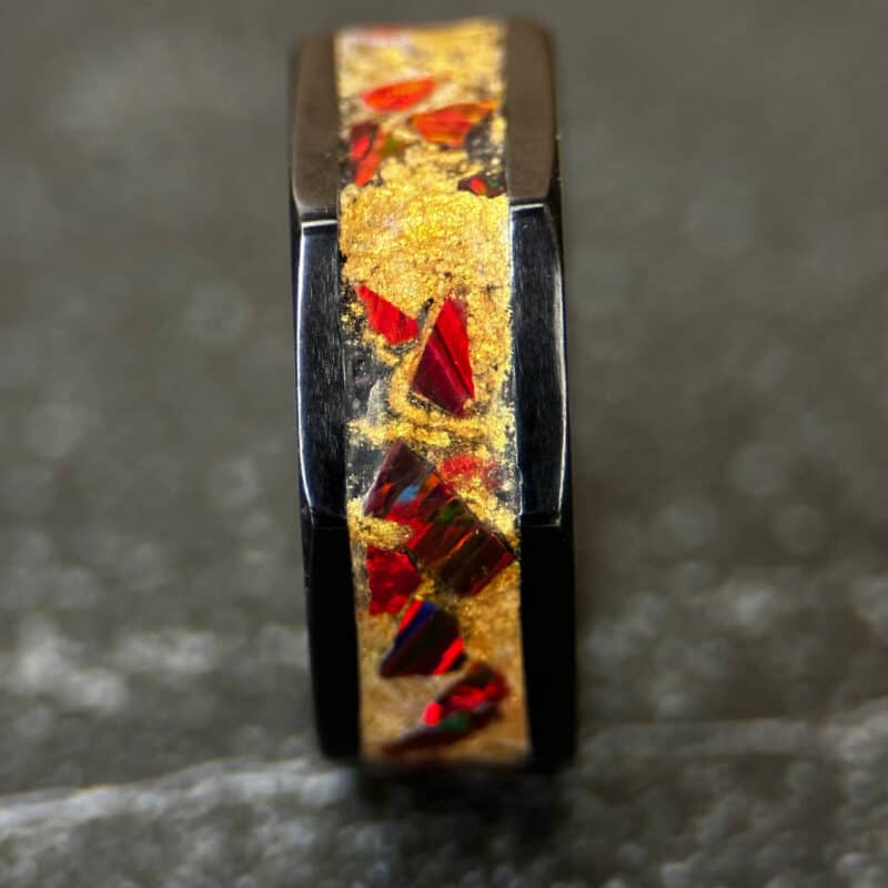 Octagon black ceramic ring with golden dust and red opal inlay.