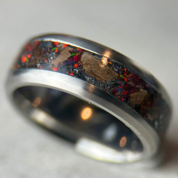 Dinosaur bone ring with meteorite fragments and magma opal.