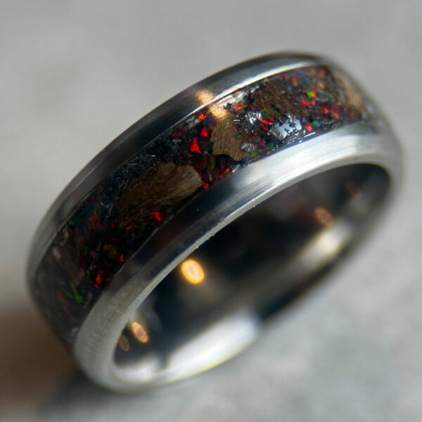 Dinosaur bone ring with meteorite fragments and magma opal.