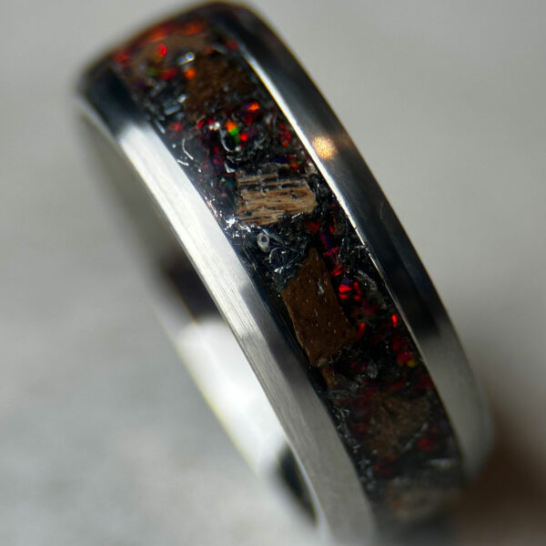 Dinosaur bone ring with meteorite fragments and magma opal.