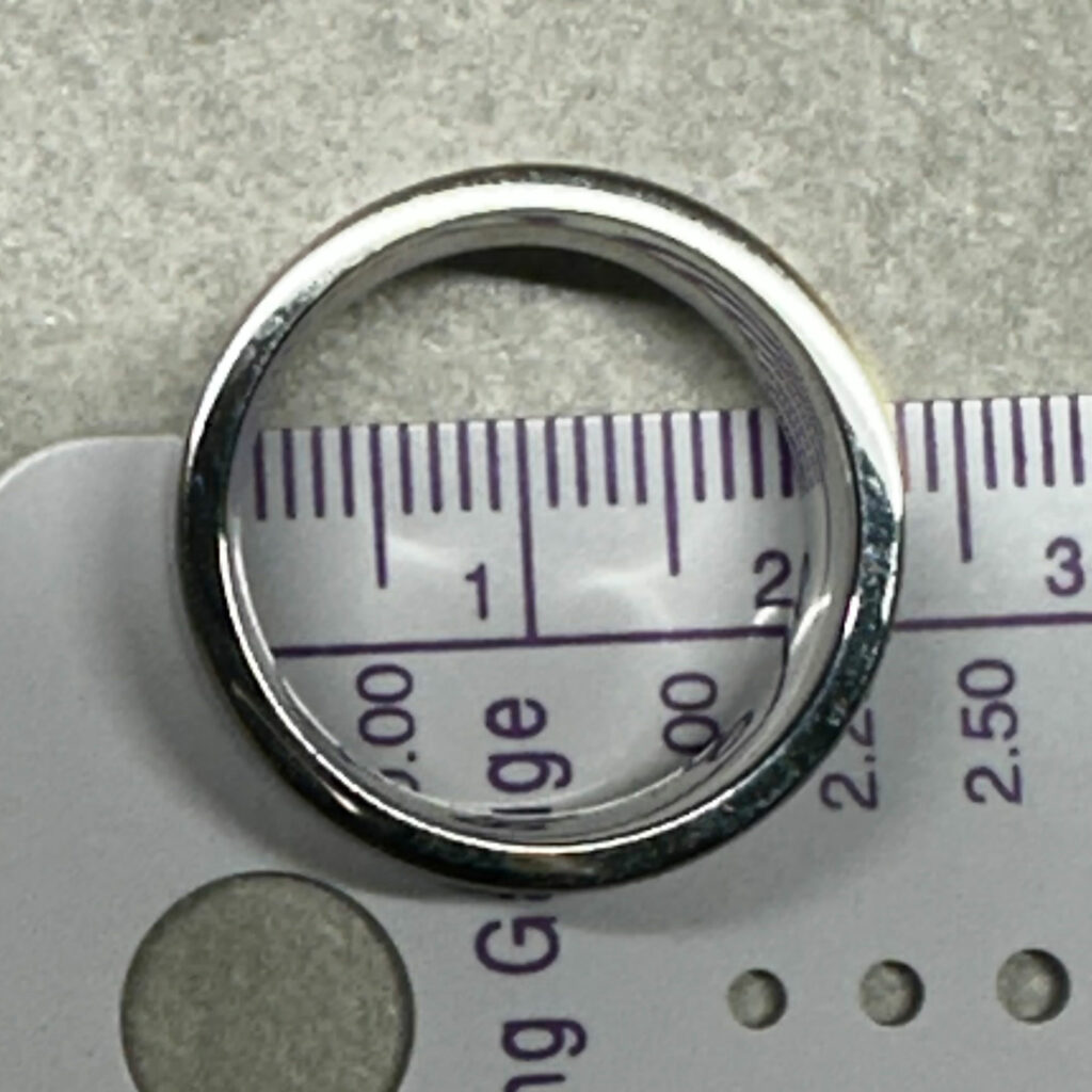 Measuring the inside diameter of a known ring size to find out the size of the ring.