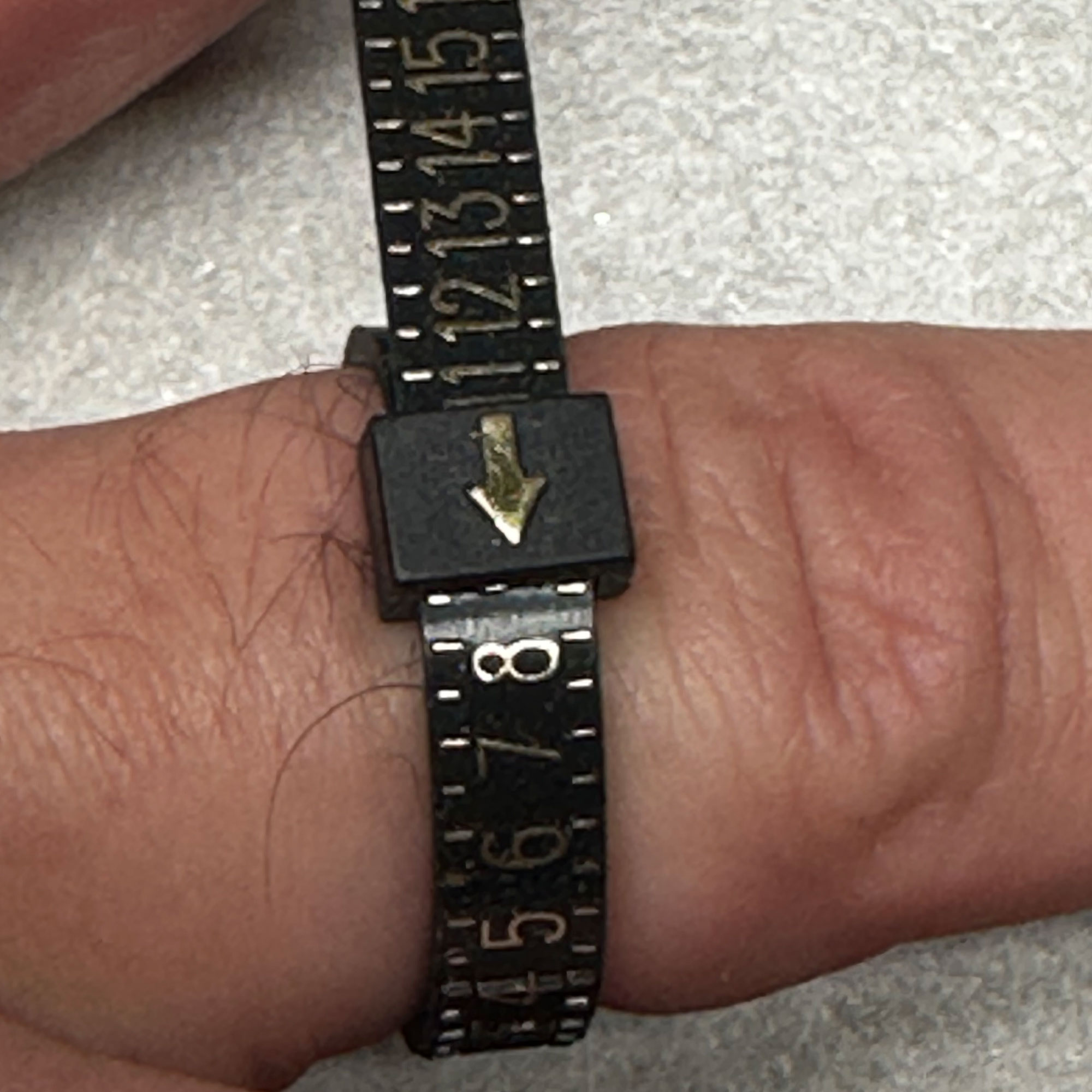 ring sizer pulled to show ring size demonstrating how to measure your ring size