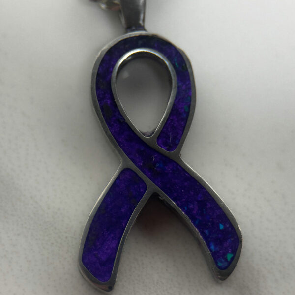 Cancer awareness ribbon in purple.