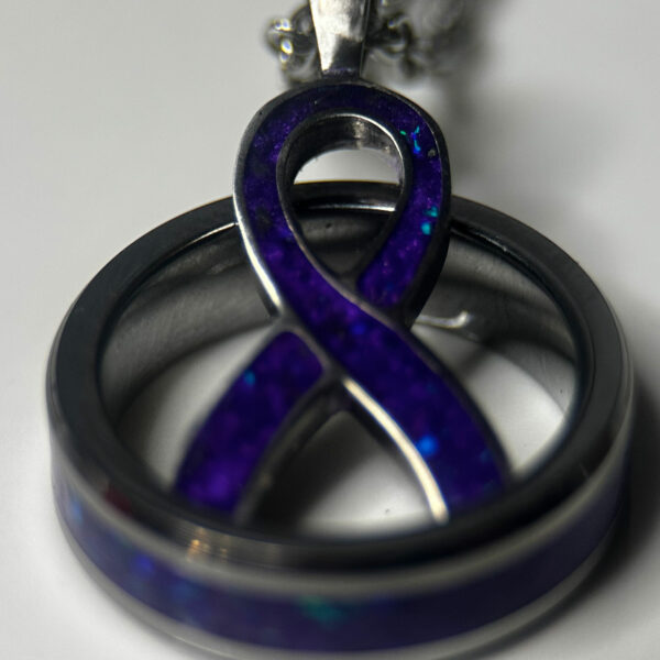 Cancer awareness ribbon in purple with purple cancer support ring.