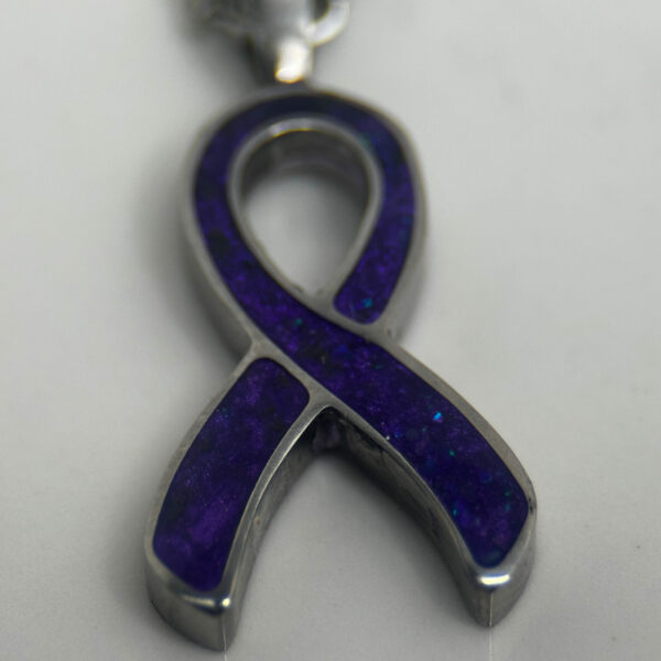 Cancer awareness ribbon in purple.