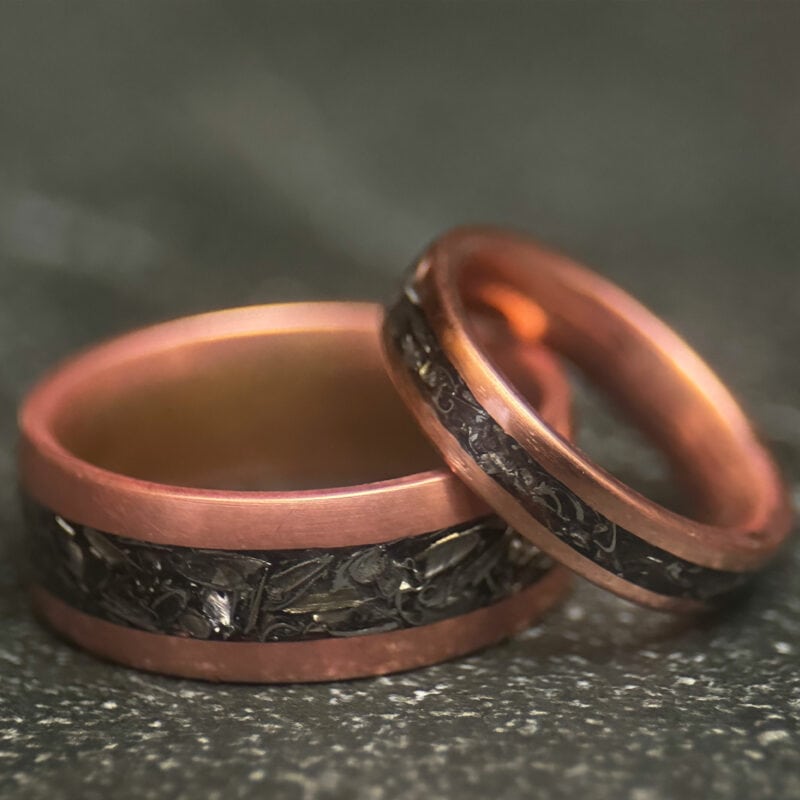Two Copper rings with tank scrap on a dark background