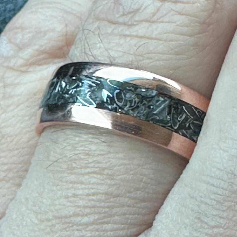 Copper ring with tank scrap on a finger