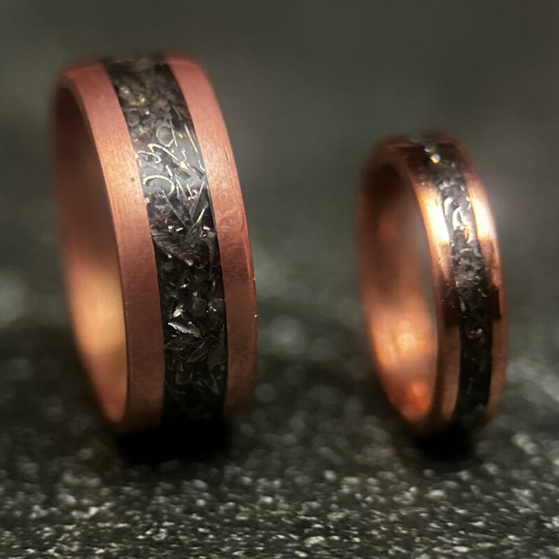 Two Copper rings with tank scrap on a dark background
