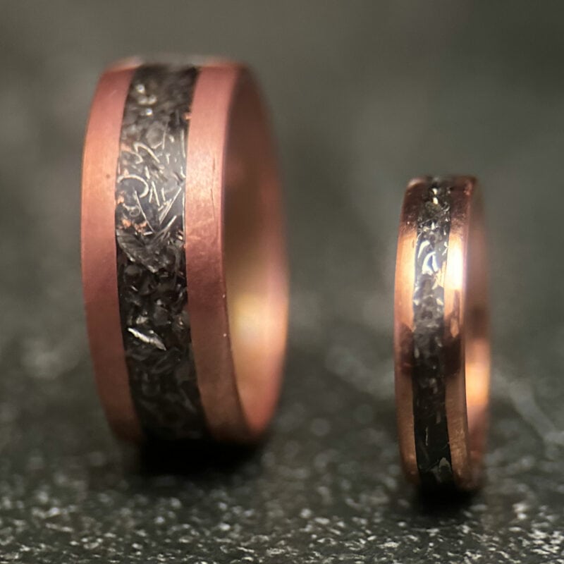 Two Copper rings with tank scrap on a dark background