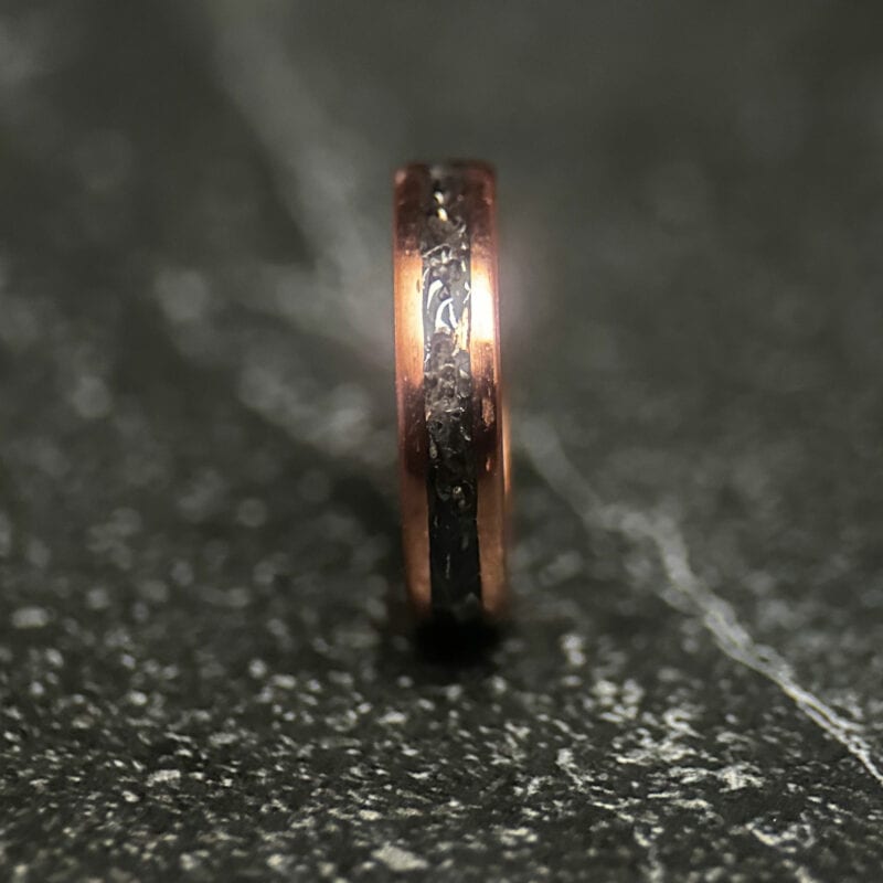 Copper ring with tank scrap on a dark background