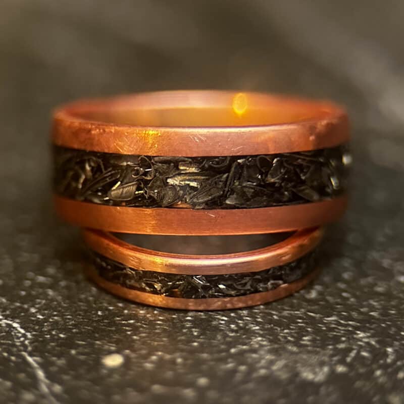 Copper ring with tank scrap on a dark background
