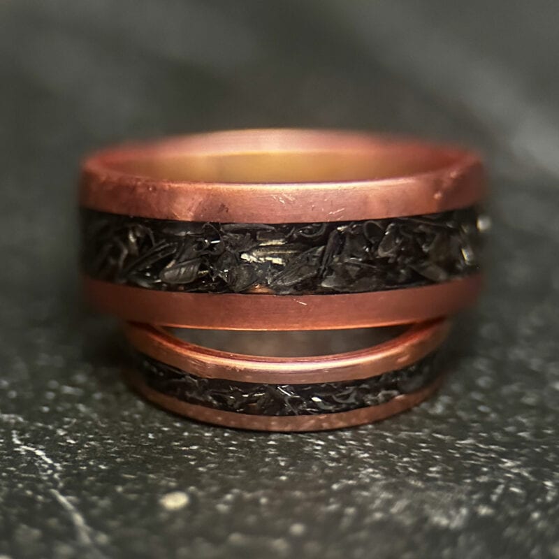 Copper ring with tank scrap on a dark background