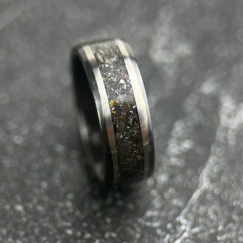 Meteorite ring with gold leaf on a dark tile