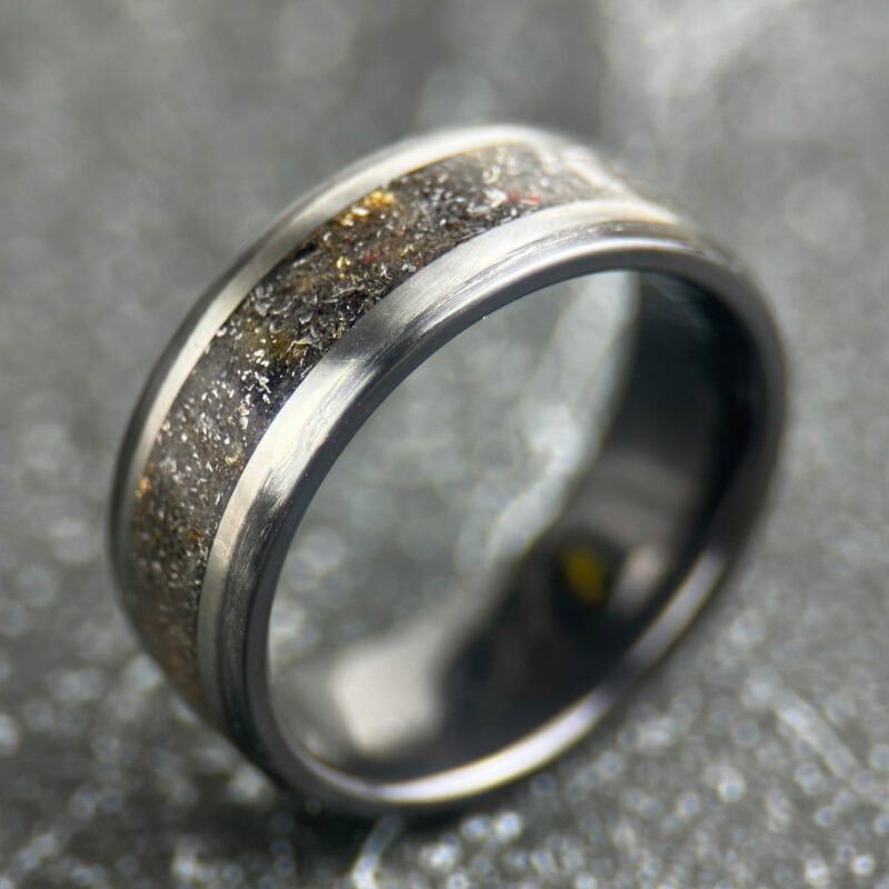 Meteorite ring with gold leaf on a dark tile
