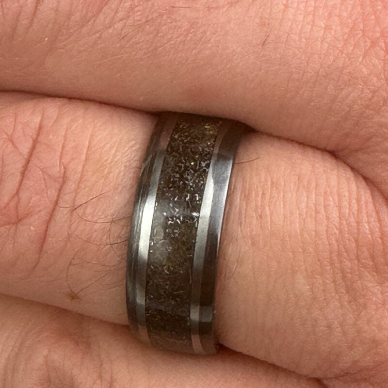 Meteorite ring with gold leaf on a finger