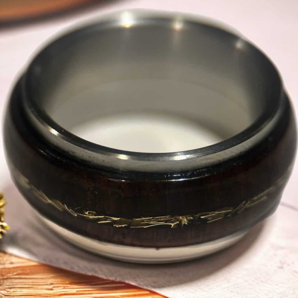 Rosewood and tank fidget ring on neutral background