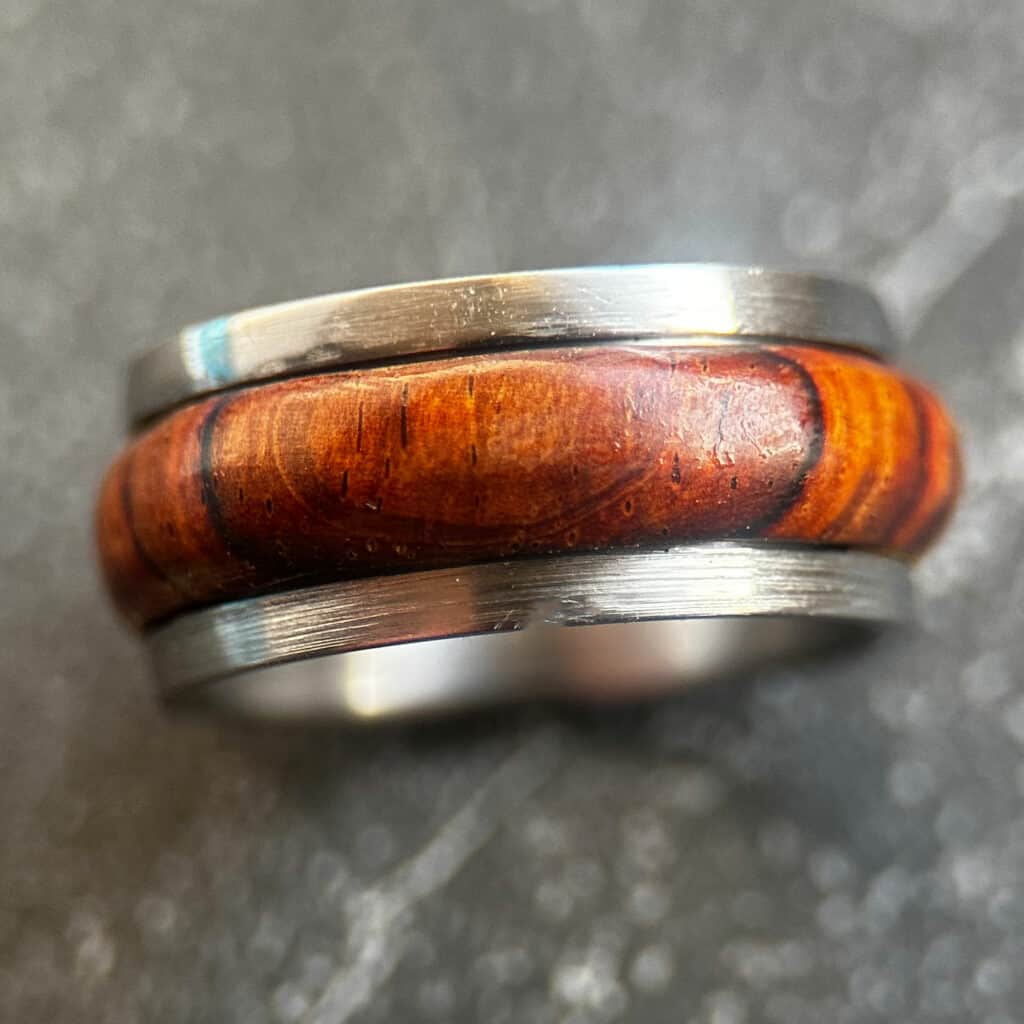 cocobolo ring set in stainless steel core shot on a neutral background.