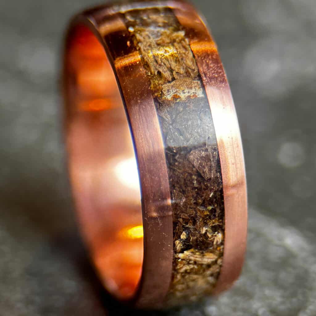 t-rex and triceratops dinosaur bone ring set in a copper ring comfort core, one of many handmade wedding rings
