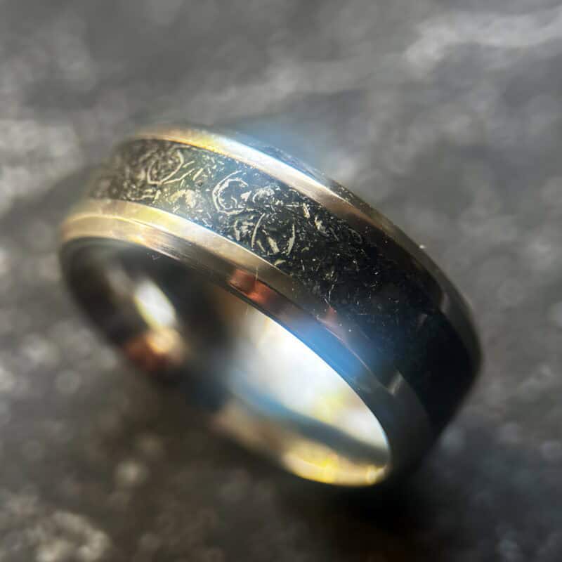 Mens wedding meteorite ring on dark background