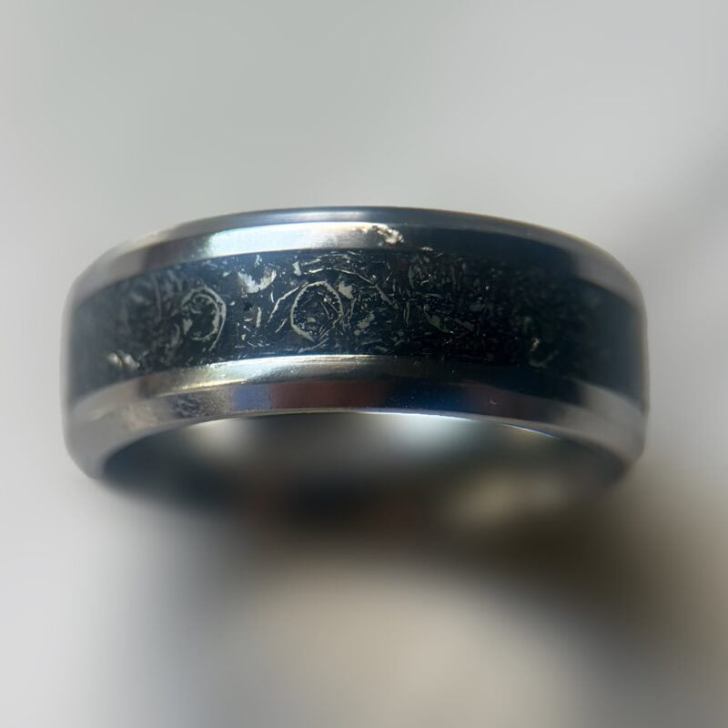 Mens wedding meteorite ring on neutral background