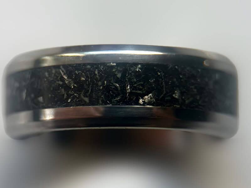 Mens wedding meteorite ring on neutral background