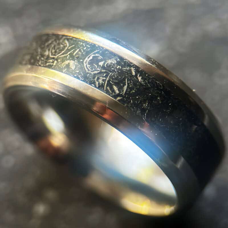 Mens wedding meteorite ring on dark background