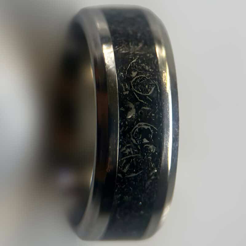 Mens wedding meteorite ring on neutral background
