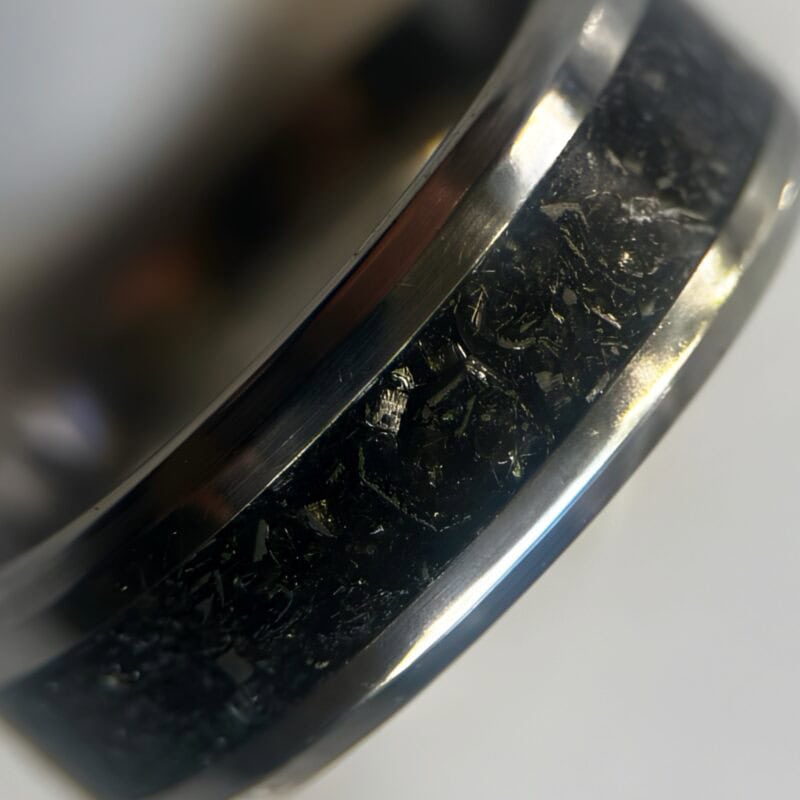 Mens wedding meteorite ring on neutral background
