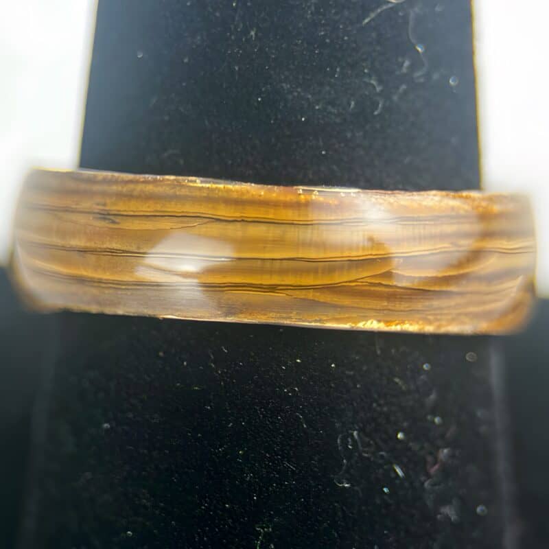 Driftwood ring with comfort copper core on ring stand.