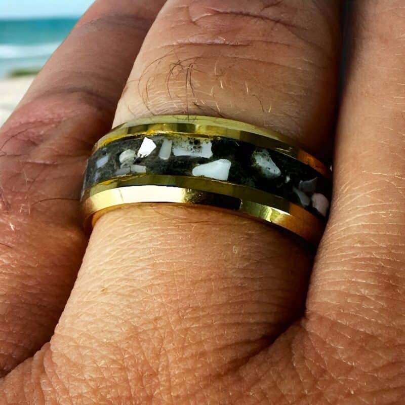 Golden Hunter - Nordic gold ring with mother of pearl and megalodon inlay on a finger