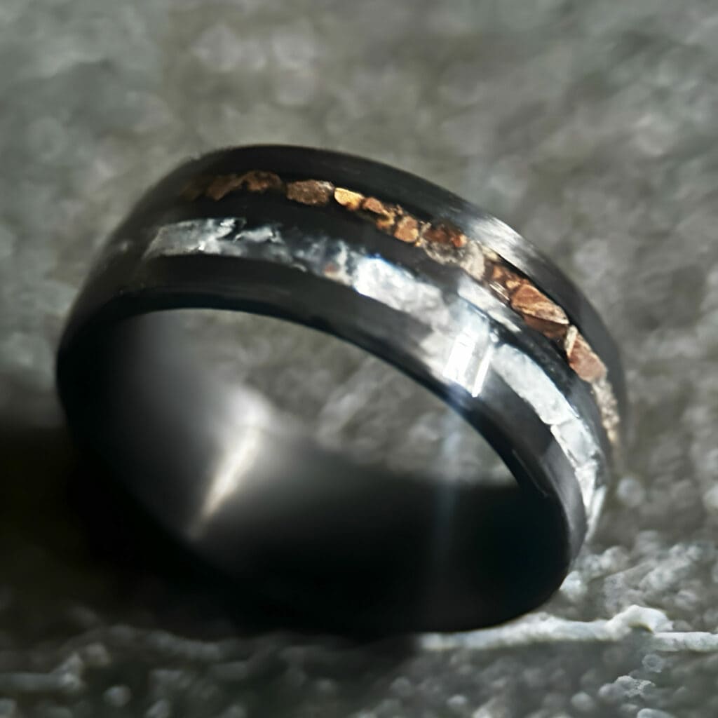 Hunter's Moonstone Ring. Moonstone and t-rex double channel ring on neutral background