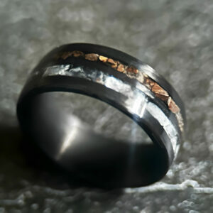 Hunter's Moonstone Ring. Moonstone and t-rex double channel ring on neutral background