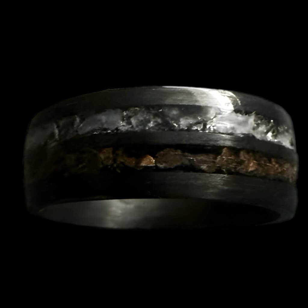 Hunter's Moon Ring. Moonstone and t-rex double channel ring on black background