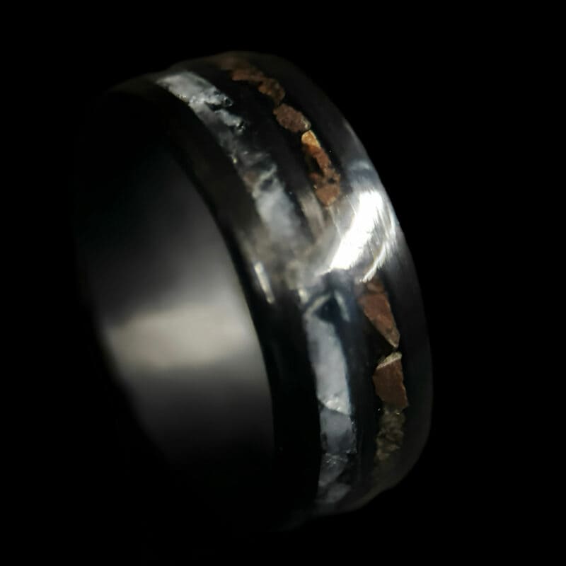 Hunter's Moon Ring. Moonstone and t-rex double channel ring on black background