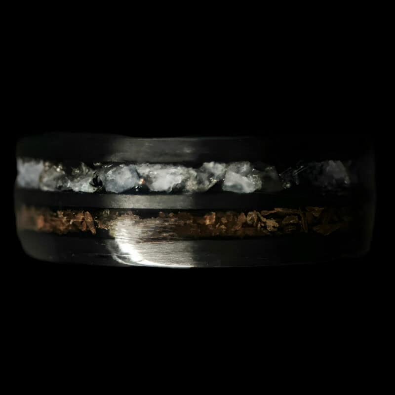 Hunter's Moon Ring. Moonstone and t-rex double channel ring on black background.