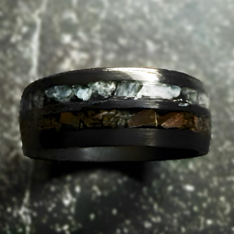 Hunter's Moon Ring. Moonstone and t-rex double channel ring on dark background.