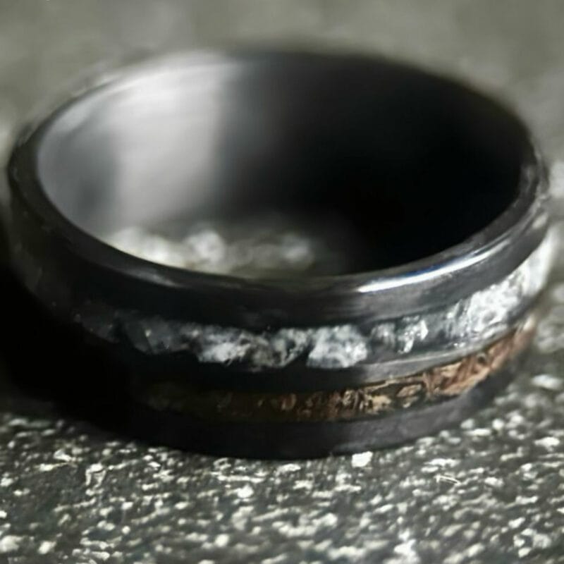 Hunter's Moon Ring. Moonstone and t-rex double channel ring on dark background.