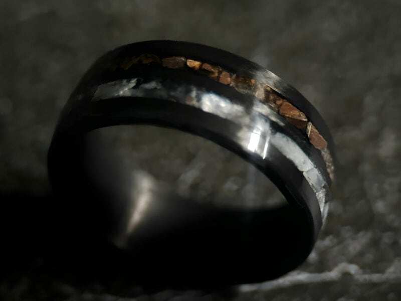 Hunter's Moon Ring. Moonstone and t-rex double channel ring on dark background.