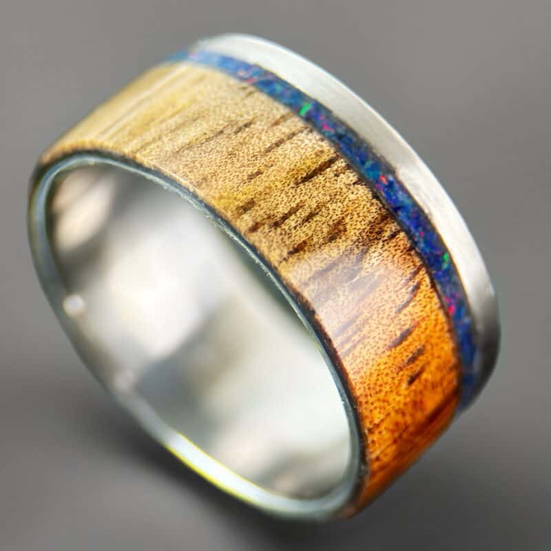 koa wood ring, live edge with stainless steel edge, stainless steel core, and opal inlay.