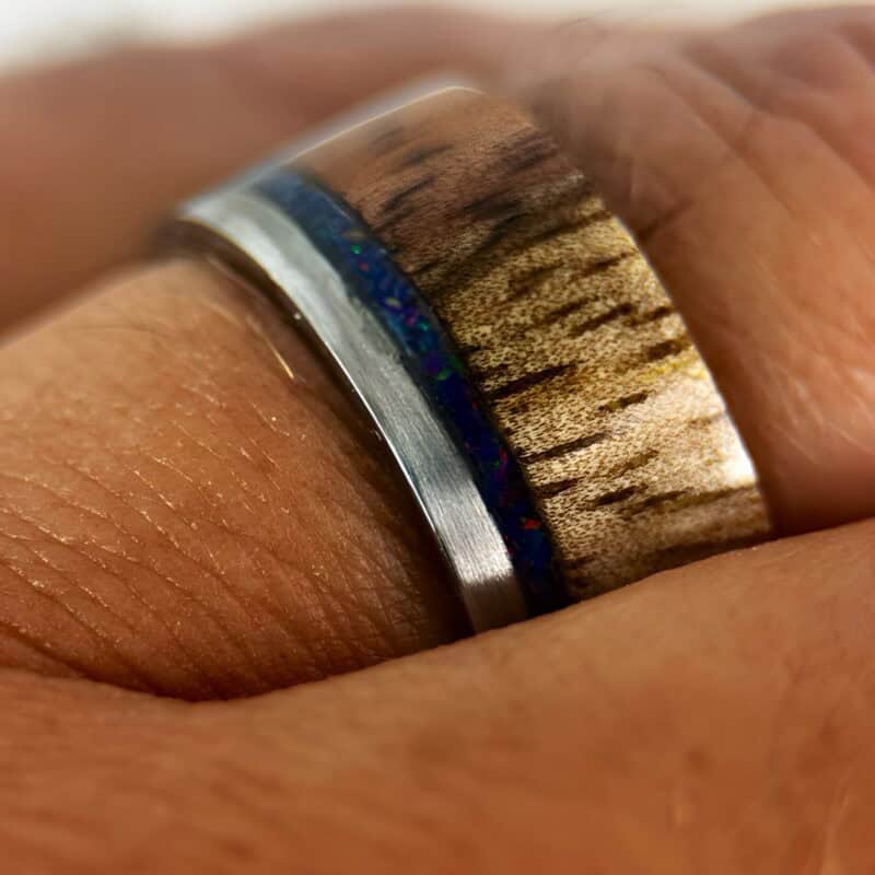 koa wood ring, live edge with stainless steel edge, stainless steel core, and opal inlay.