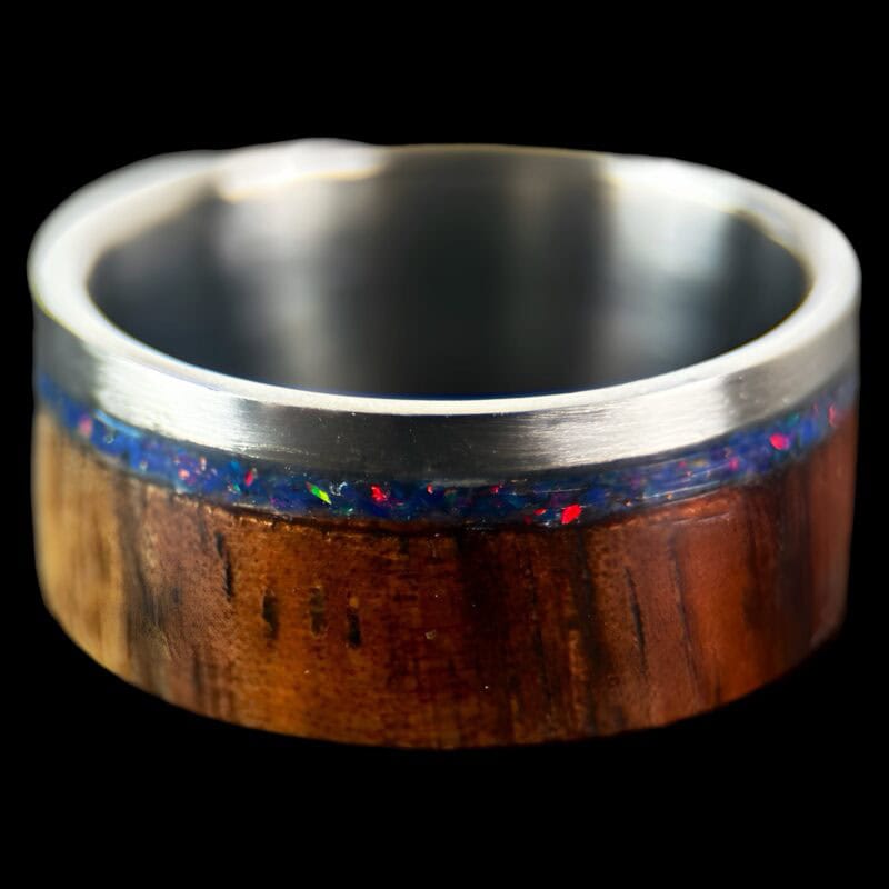 koa wood ring, live edge with stainless steel edge, stainless steel core, and opal inlay.