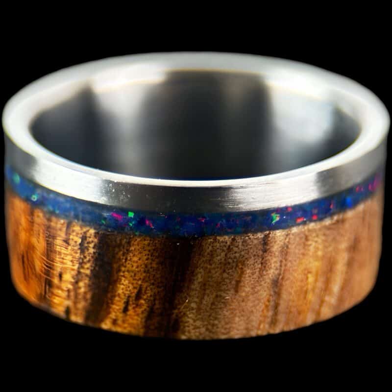 koa wood ring, live edge with stainless steel edge, stainless steel core, and opal inlay.
