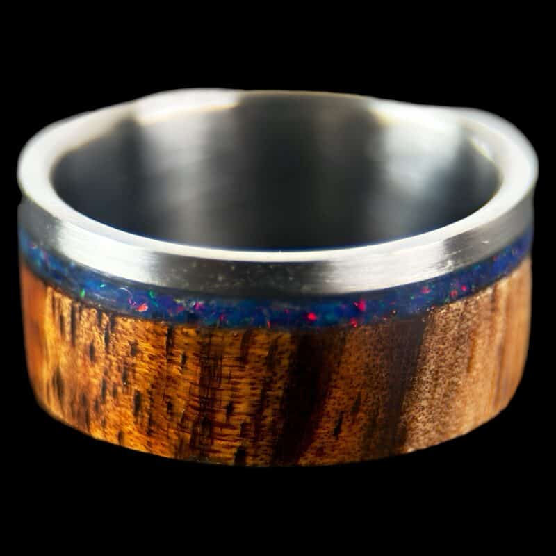 koa wood ring, live edge with stainless steel edge, stainless steel core, and opal inlay.