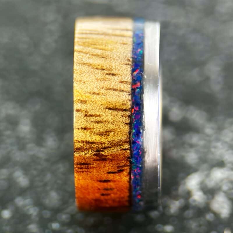 koa wood ring, live edge with stainless steel edge, stainless steel core, and opal inlay.